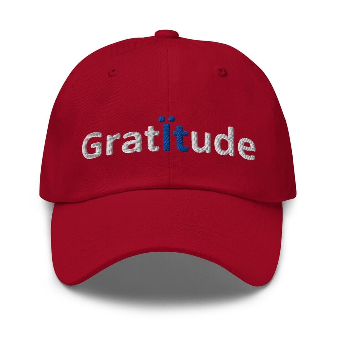 Red baseball cap embroidered "Gratitude"