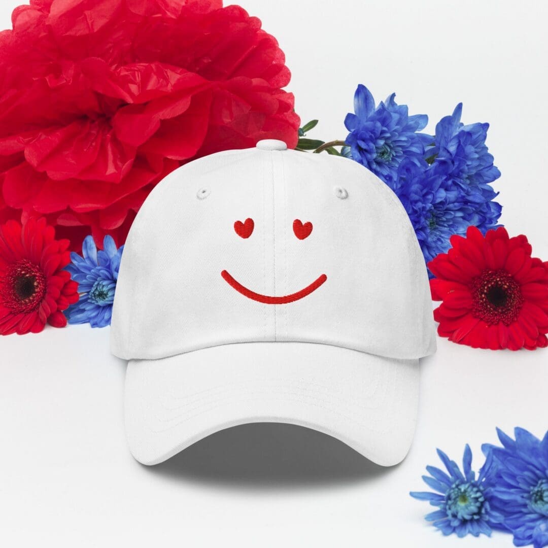 White cap with heart-eyed smile and flowers